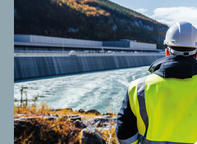 Hydroelectricity Dam Inspection An Engineer Inspecting With A Hydroelectricity Dam In The Background