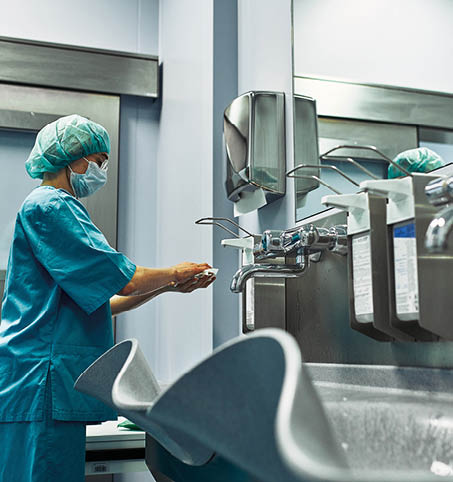 The doctor washes his hands before surgery. Sterility concept. A professional surgeon washes his hands in a special room before the operation
