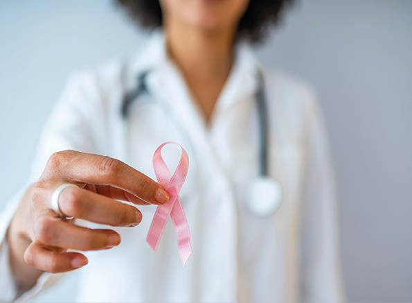 Female Doctor Holds Pink Ribbon, International Breast Cancer Day October 7. October Breast Cancer Awareness month, Woman holding Pink Ribbon. International Women day and World cancer day concept