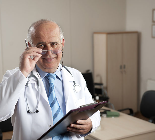 Un médecin senior souriant tient en main un dossier - MACSF