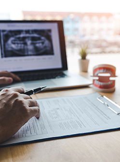 Le chirurgien-dentiste complète le questionnaire médical du patient - MACSF