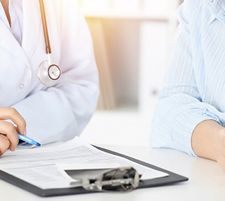 Un médecin remplit un document avec sa patiente - MACSF