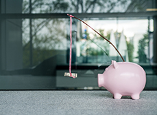 Un bâton avec un billet, accroché à une tirelire - MACSF