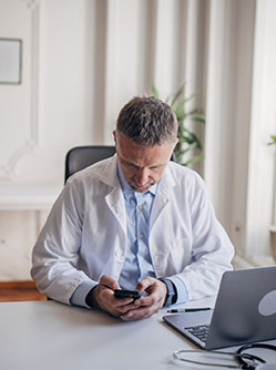 Un professionnel de santé regarde son téléphone - MACSF