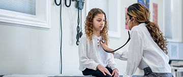 Une femme médecin ausculte une adolescente - MACSF