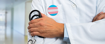 Médecin en blouse blanche avec stéthoscope et badge transgenre - MACSF
