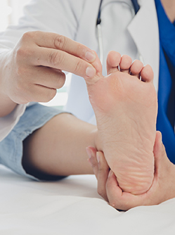 Le médecin ausculte le pied d'une patiente - MACSF
