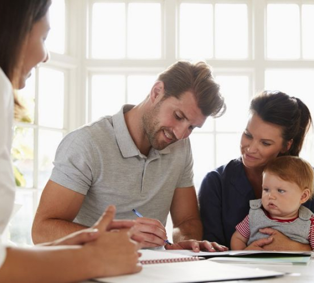 Des parents ouvrent un contrat d'épargne pour leur enfant.